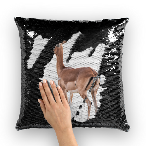 Black sequinned cushion that has a hidden large print impala when swiped