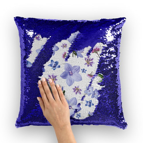 Purple sequinned cushion that has a hidden blue and purple floral print with a white background