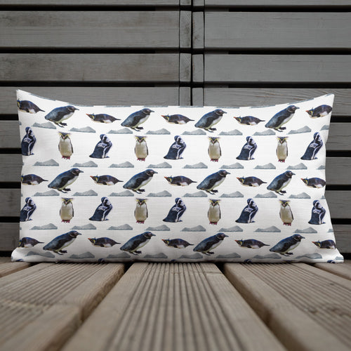 White rectangular pillow with penguins and icebergs.