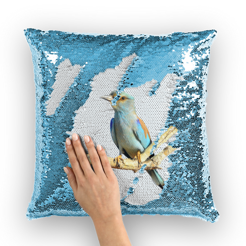 Blue sequinned cushion that has a hidden large print roller bird when swiped