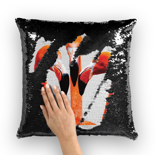 Black sequinned cushion that has a hidden large print orange flamingos when swiped