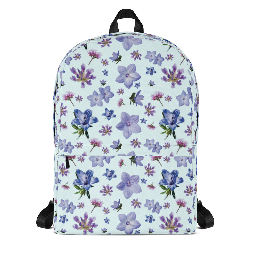 Front of light blue backpack with a blue and purple floral pattern