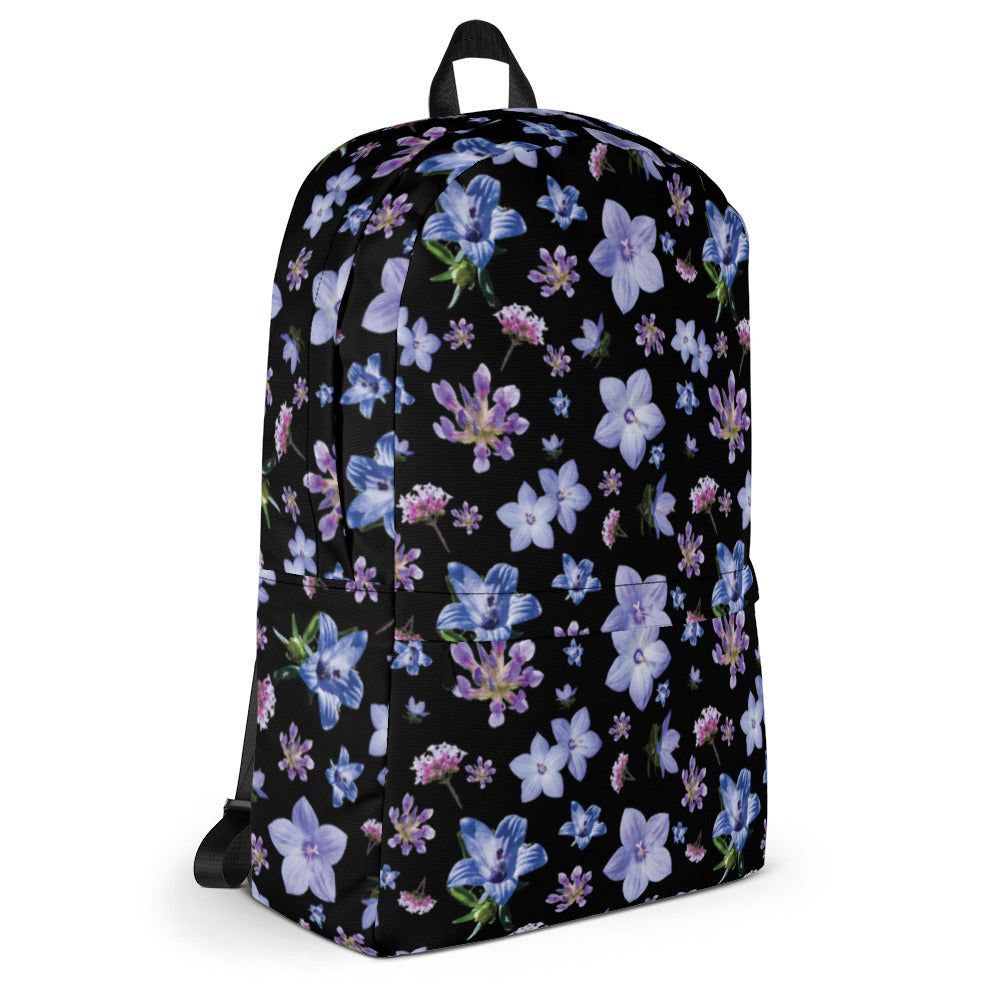 Black floral backpack in a water resistant material from the left side.