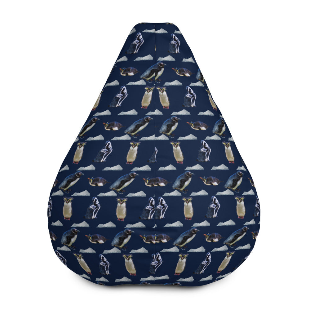 Back of dark navy bean bag chair with repeating pattern of penguins and icebergs