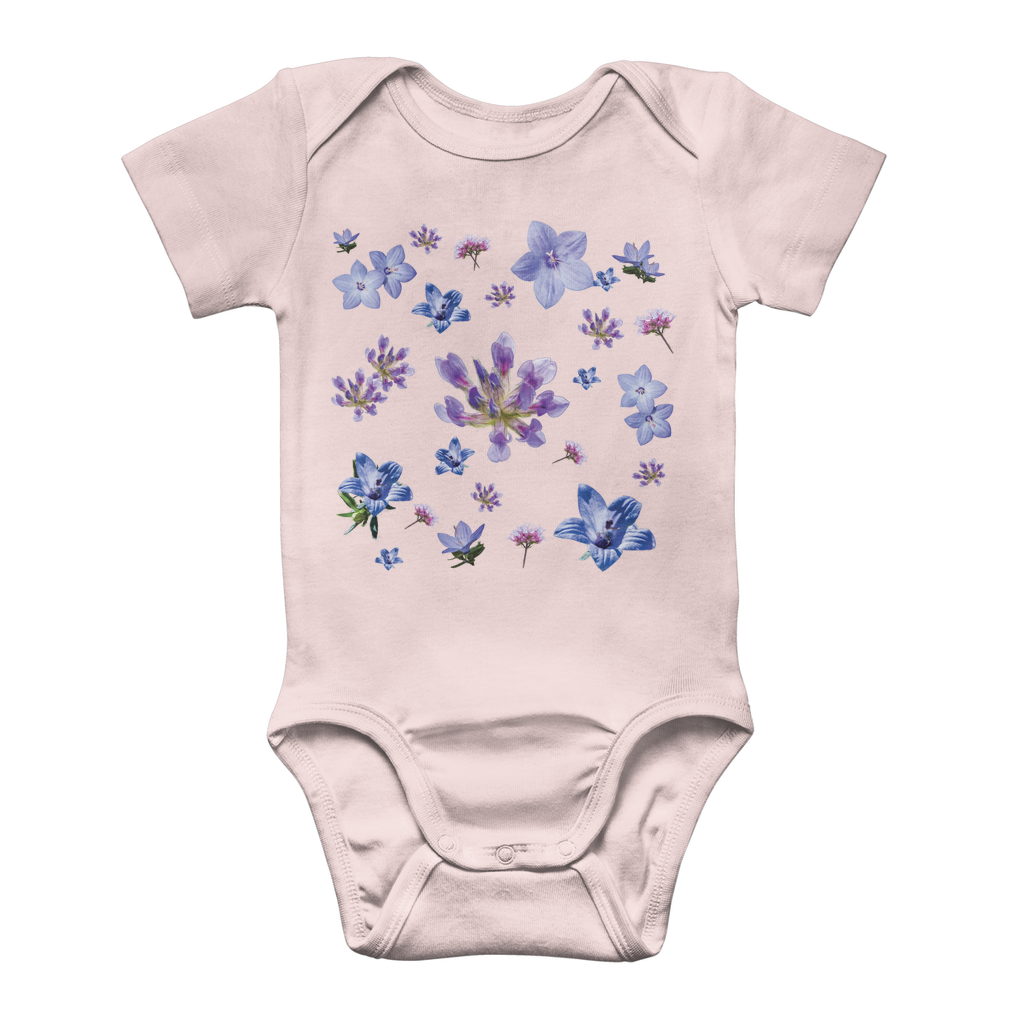 Light pink onesie for babies with a blue and purple floral pattern on front